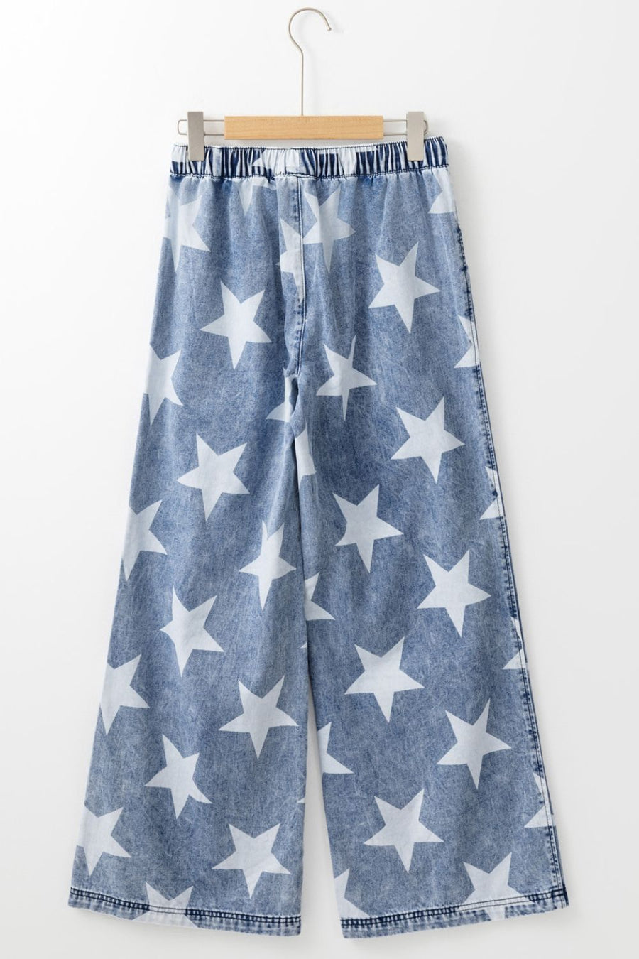 Cosmic Wash Star Print Palazzo Jeans in medium wash denim with white stars and an elastic waistband.