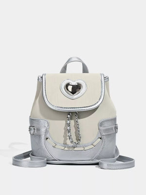 Charming mini heart flap backpack in cream and silver with chain detail.