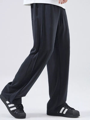 Black relaxed fit joggers with drawstring and side stripe detail.