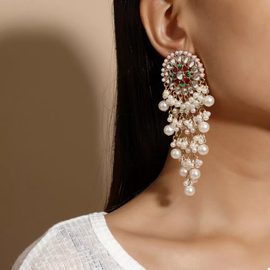 Lustrous pearl fringe statement earrings with gold alloy and color accents.