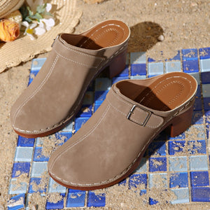 Beige round toe platform slip-ons with buckle detail and contrast stitching.