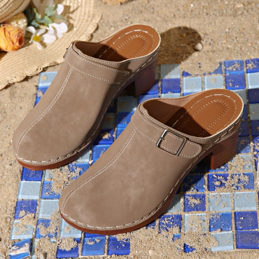 Beige round toe platform slip-ons with buckle detail and contrast stitching.