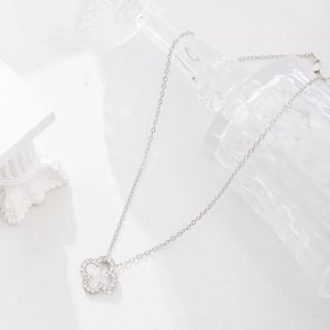 Elegant clover pendant necklace in silver with sparkling stones.