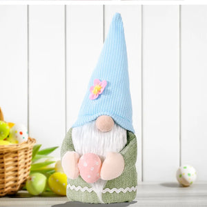 Bunny ear gnome decoration in green with pink Easter egg and blue knit hat with flower accent.