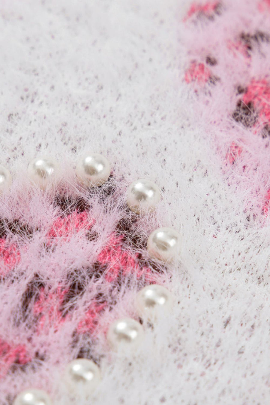 Fuzzy knit sweater in blush pink with jacquard heart pattern and pearl embellishments.