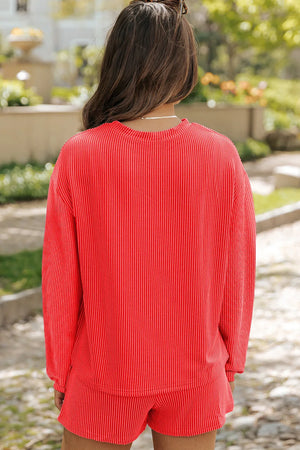 Orange-red ribbed loungewear top with crew neck and long sleeves.