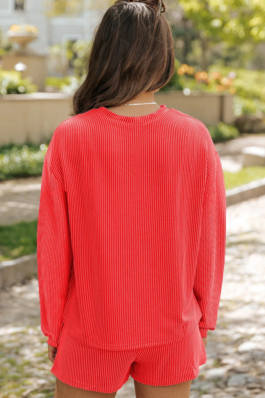 Orange-red ribbed loungewear top with crew neck and long sleeves.