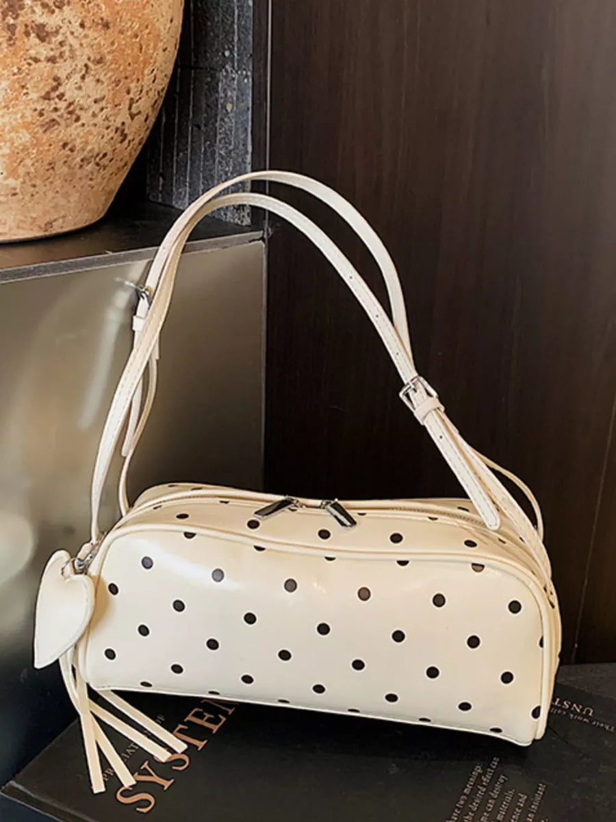 Ivory polka dot shoulder bag with heart charm and fringe detail