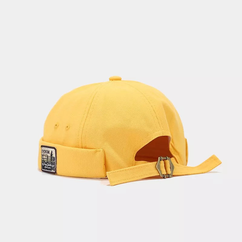 hat in yellow featuring brimless and fitted fit