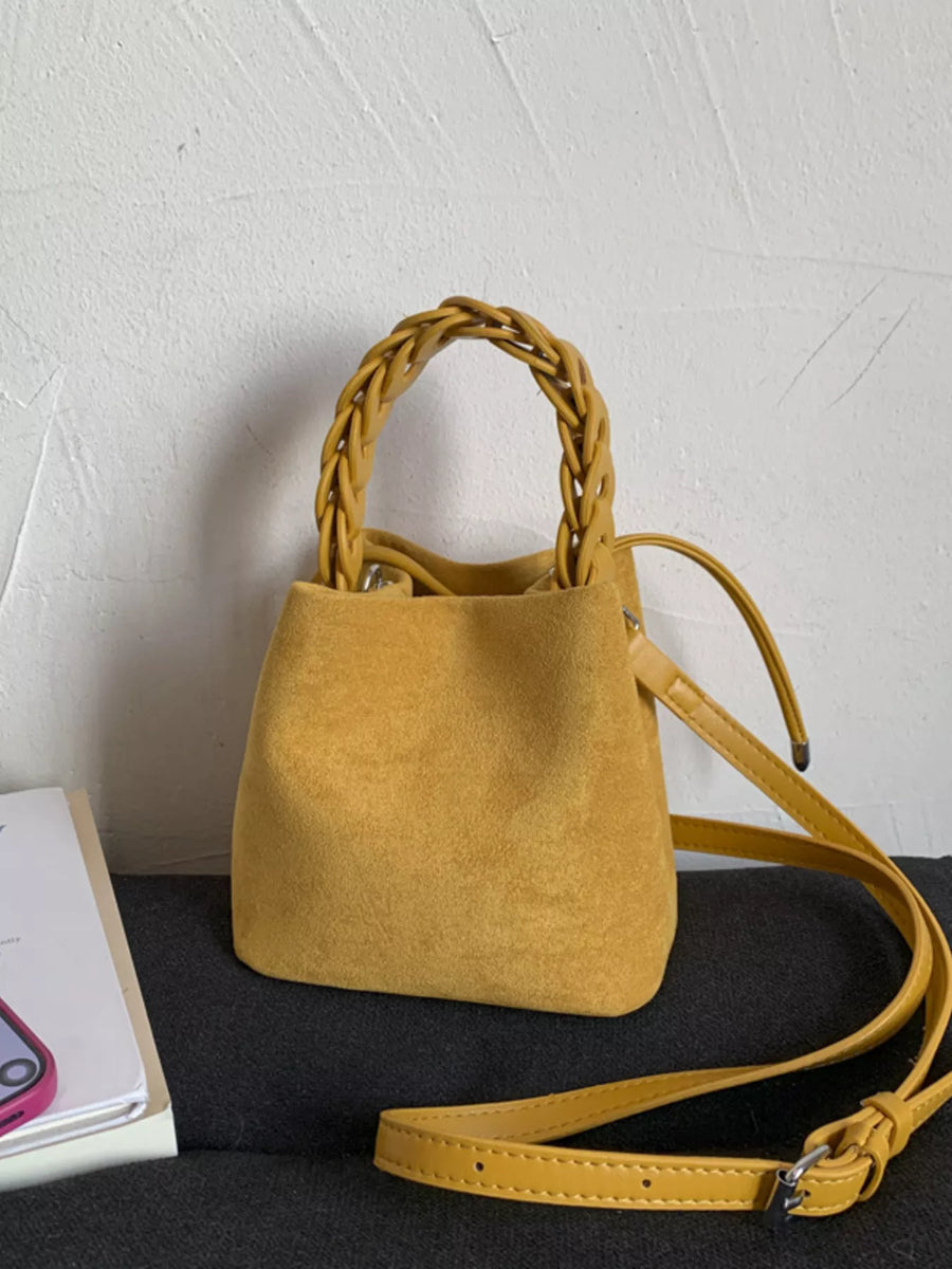 Yellow crossbody bag with braided handle and adjustable strap