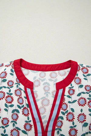 Vibrant floral midi dress with red trim, blue and red striped V-neck detail.