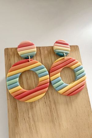 Textured rainbow hoop earrings with multicolor stripes and a circular design.