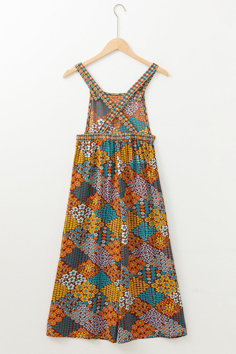 Floral patchwork culotte jumpsuit with wide legs and a cinched waist.