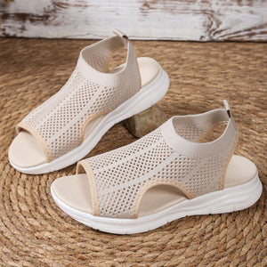 Beige mesh open-toe sandals with a chunky sole and comfortable design.