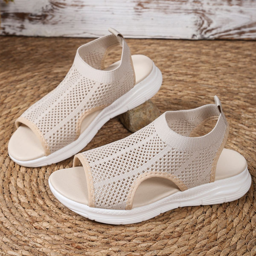 Beige mesh open-toe sandals with a chunky sole and comfortable design.
