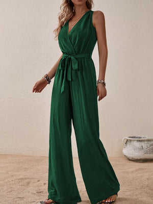 Dark green V-neck tie-waist wide-leg romper with textured fabric.