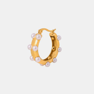 Gold hoop earrings with sculpted pearls and a polished finish.