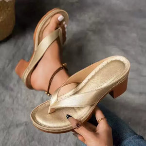 Gold toe-post block heel sandals with a comfortable cushioned footbed and ankle chain detail.