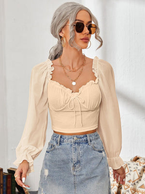 Tan bustier sleeve blouse with sweetheart neckline and tie front detail