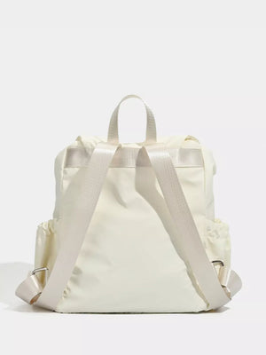 Cream nylon drawstring backpack with flap closure and adjustable straps.