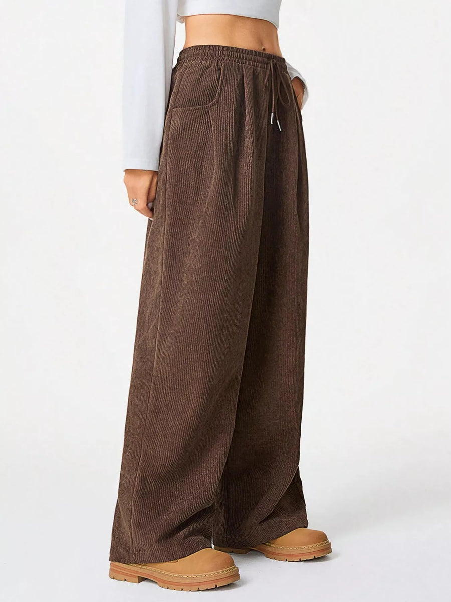 Brown corduroy pants with drawstring waist and wide leg.