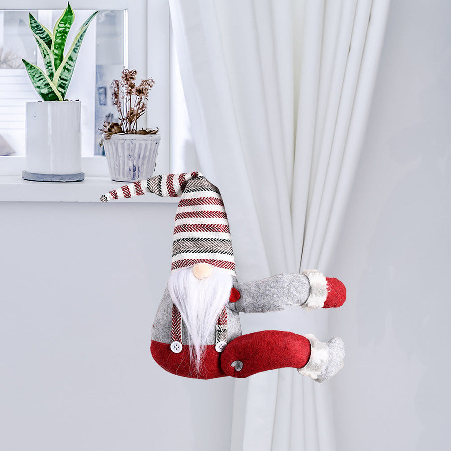 Charming gnome curtain tie-back in red and gray with striped hat, holding white curtains.