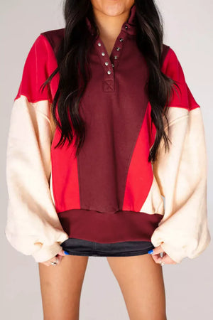 red sweatshirt featuring buttoned and color-block