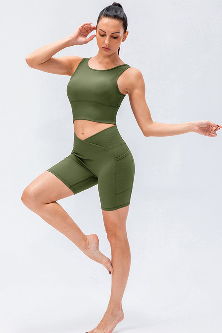 Cross-waist active bike shorts in Matcha Green with pockets.