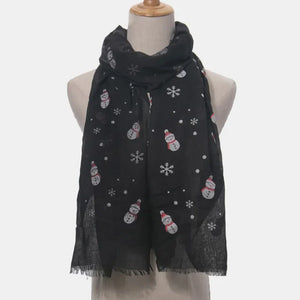 Black scarf with festive snowman and snowflake print, frayed hem