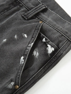 Dark gray bootcut jeans with white paint splatters and brass button details.