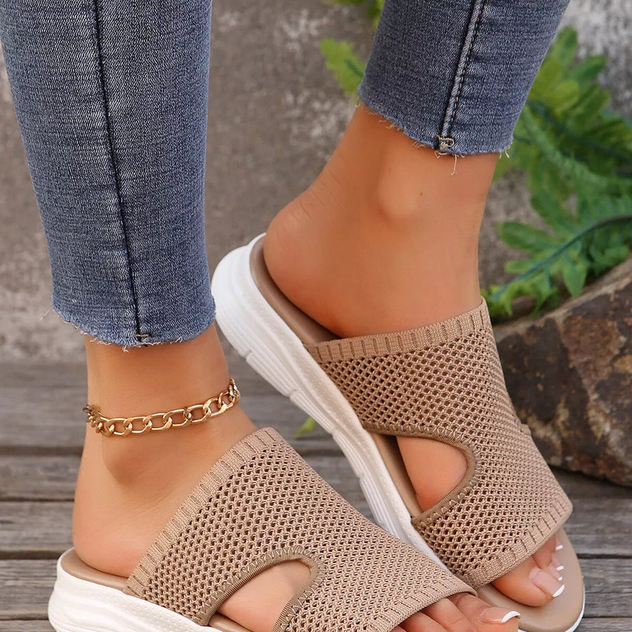 Khaki mesh slide sandals with open toe and white platform sole.