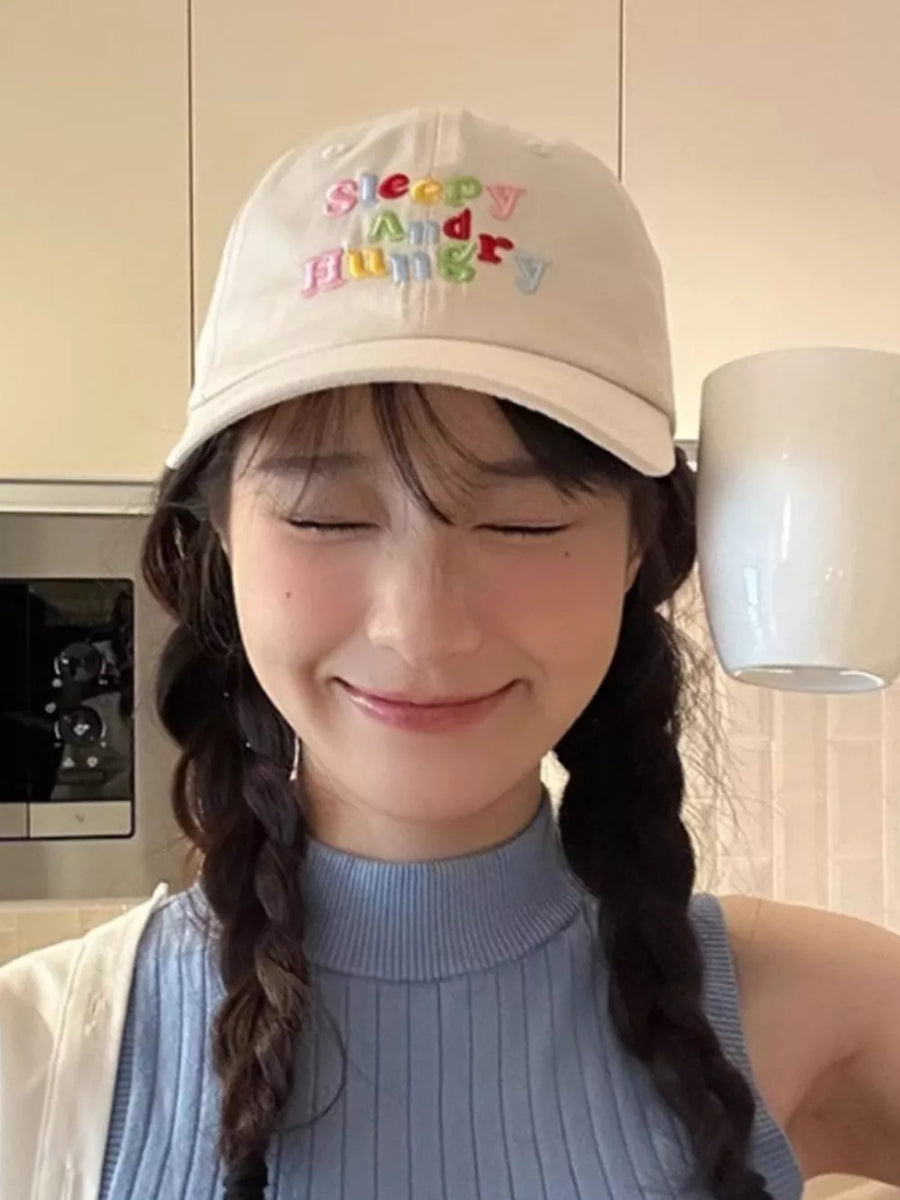 Beige baseball cap with colorful "Sleepy And Hungry" embroidery