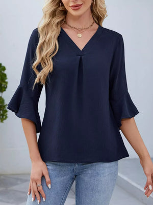 Navy V-neck blouse with ruffle sleeves and a textured fabric.