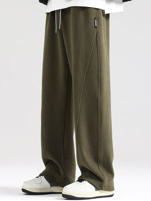 Men's army green wide-leg sweatpants with drawstring waist and seam detail.