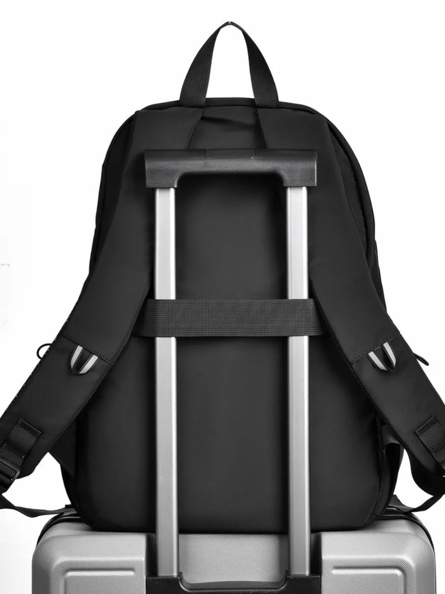 Black urban commuter backpack with luggage strap and trolley sleeve detail