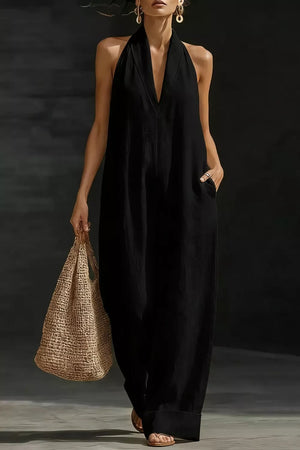 Black halter-neck pocketed maternity jumpsuit with deep V-neck and wide legs.
