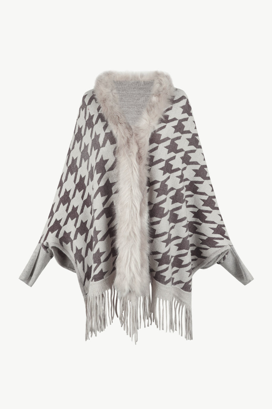 Houndstooth knit poncho with faux fur collar and fringe hem.