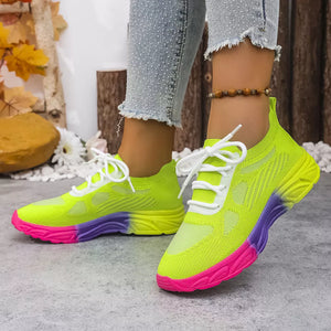 Breathable mesh lace-up sneakers in neon yellow with pink and purple sole.