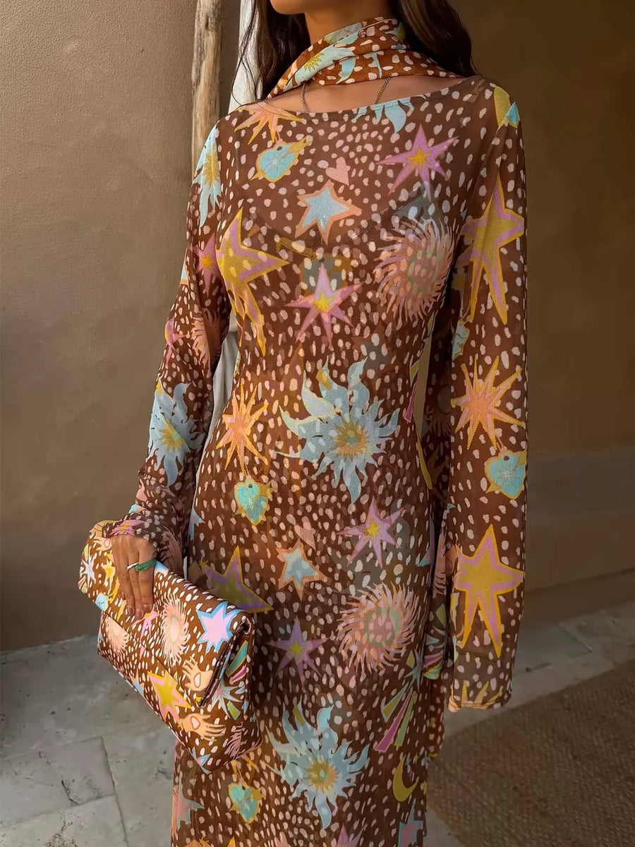 Brown celestial print maxi dress with long sleeves and cutout neckline, paired with matching clutch.