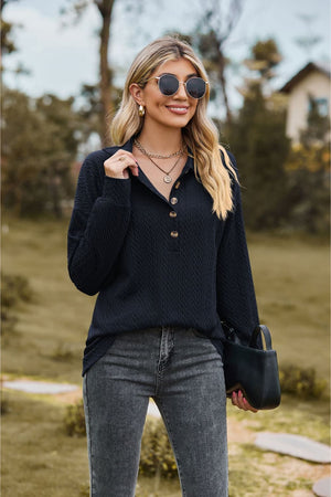Textured knit polo shirt in dark blue with buttoned placket and long sleeves.
