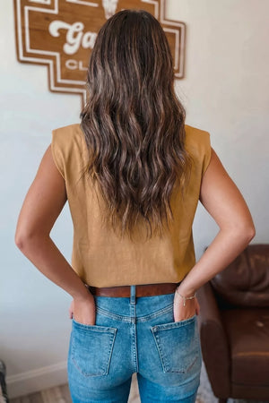 Taupe sleeveless tank top with shoulder pads, styled with jeans.