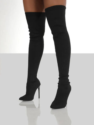 Black knit over-the-knee stiletto boots with pointed toe and ribbed cuff.