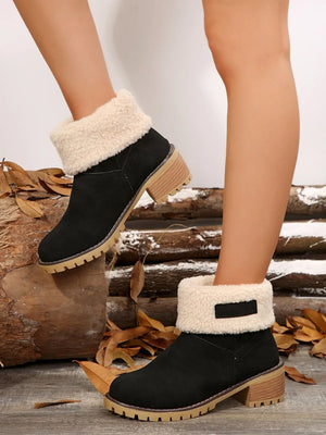 Black suede ankle boots with sherpa trim and lug sole.