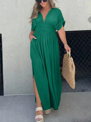 Green V-neck dolman sleeve maxi dress with smocked waist and side slits.