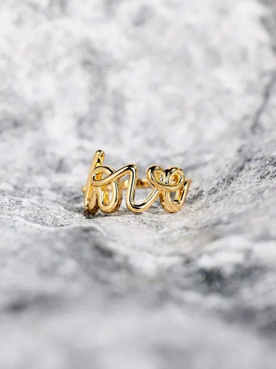 Gold scripted love ring with delicate cursive lettering