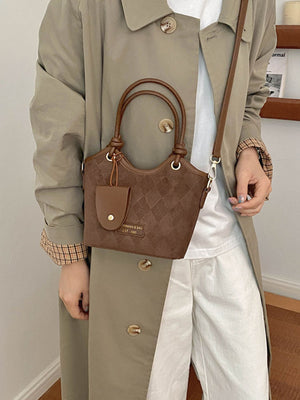 Brown crossbody bag featuring quilted and quilted