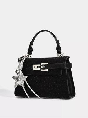 Chic mini tote bag in black faux leather with silver buckle and star charm.