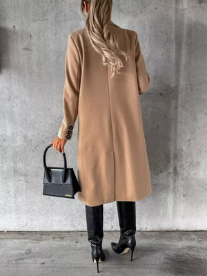 Chic double-breasted longline trench coat in apricot with button details.
