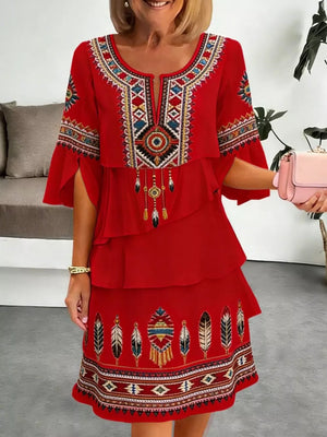 Red boho ruffled tiered dress with embroidered neckline and hem.
