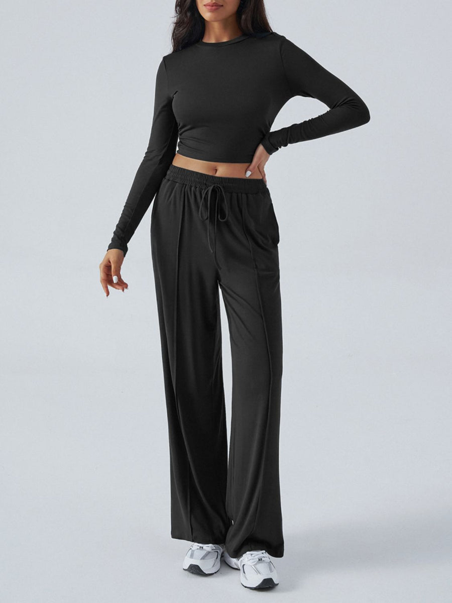 Black ribbed knit long sleeve crop top and drawstring wide leg pants set.